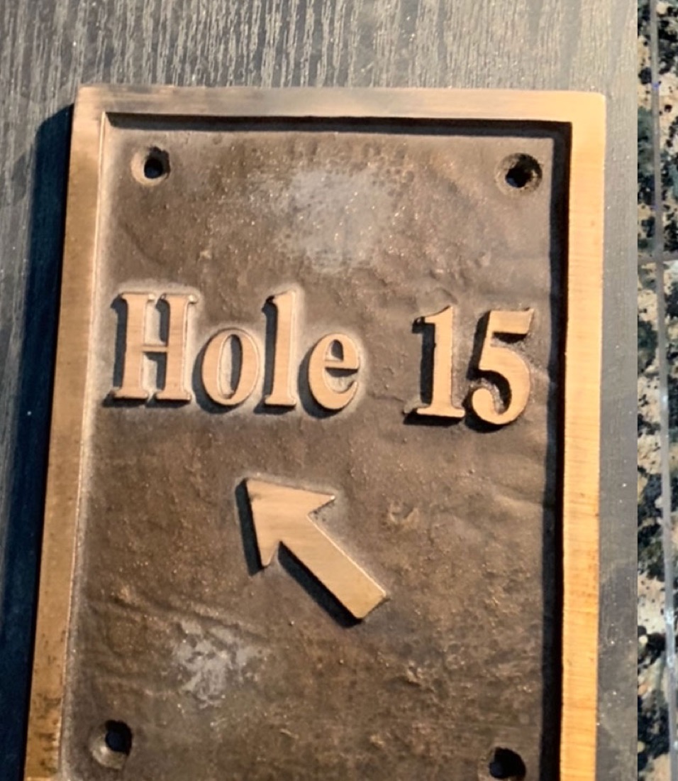 The same 'Hole 15' plaque before refinishing, oxidized and weathered